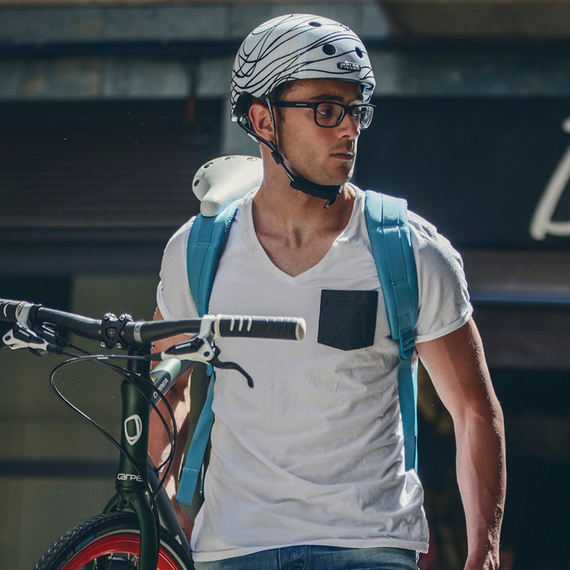 Man holding his Bike while wearing a Melon "Scribble" Helmet
