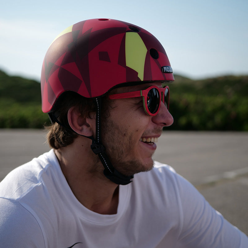 Man sitting in nature while wearing a Melon Urban Active "Ember" Bicycle Helmet