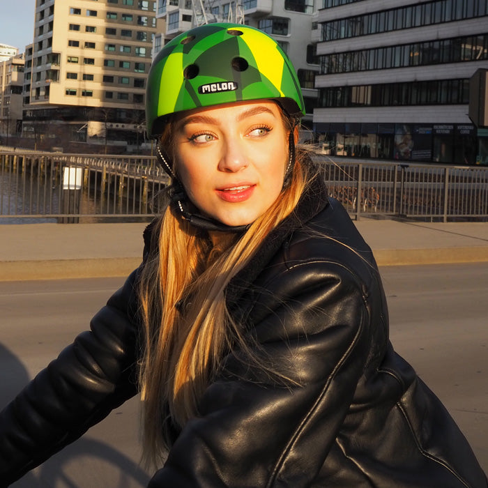 Woman wearing a green Melon Bicycle Helmet