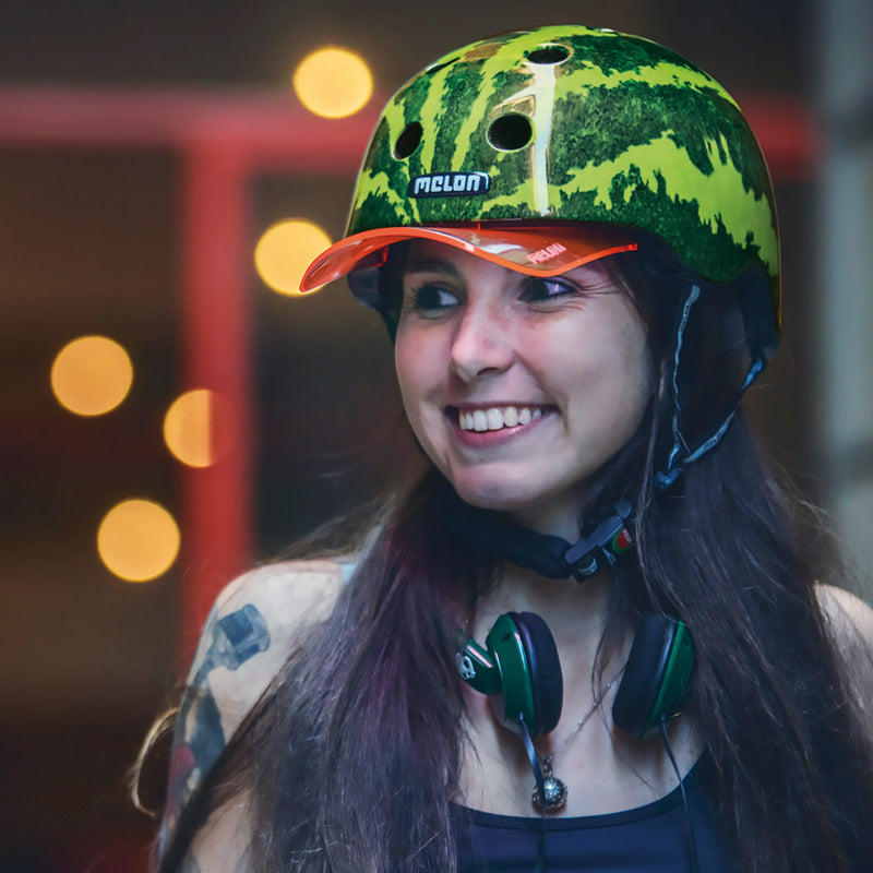 Happy Woman wearing a Melon "Real Melon" Bicycle Helmet with a red Visor