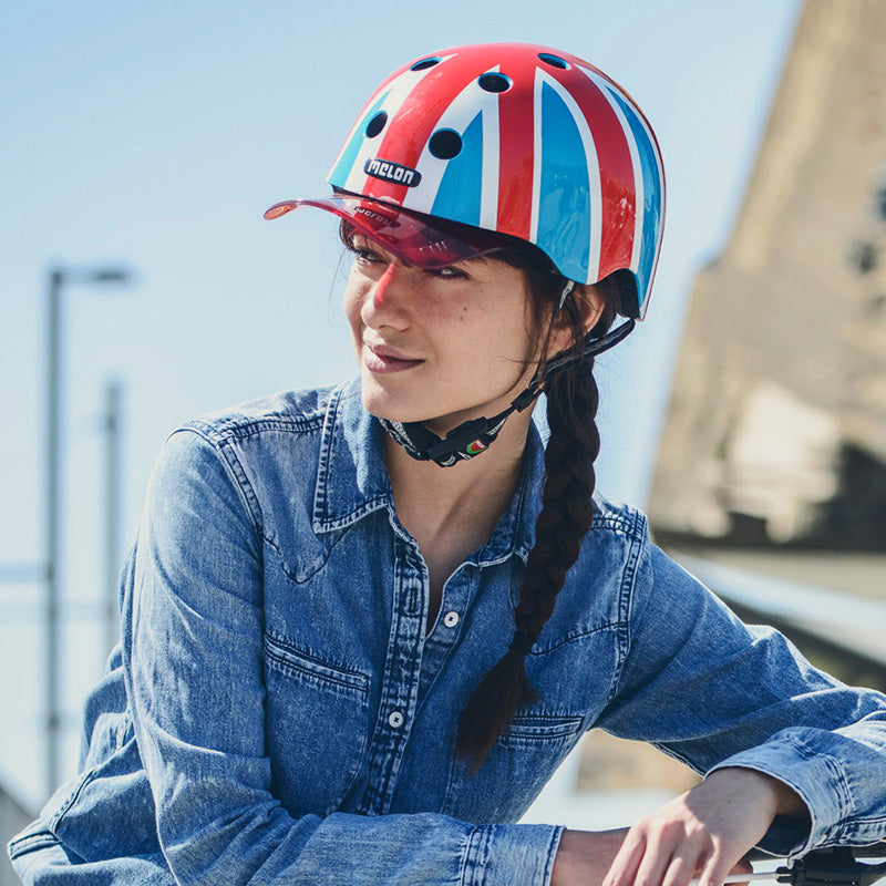 Woman wearing a Union Jack Summer Sky Melon Helmet with a red Visor