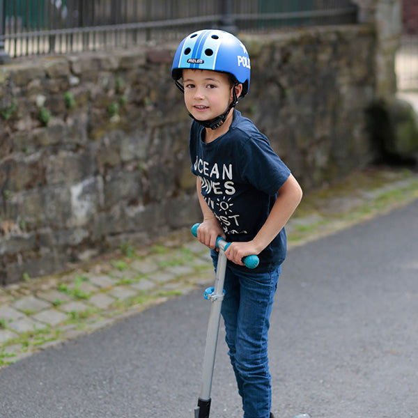 Boy riding his scooter while wearing his blue Melon police helmet